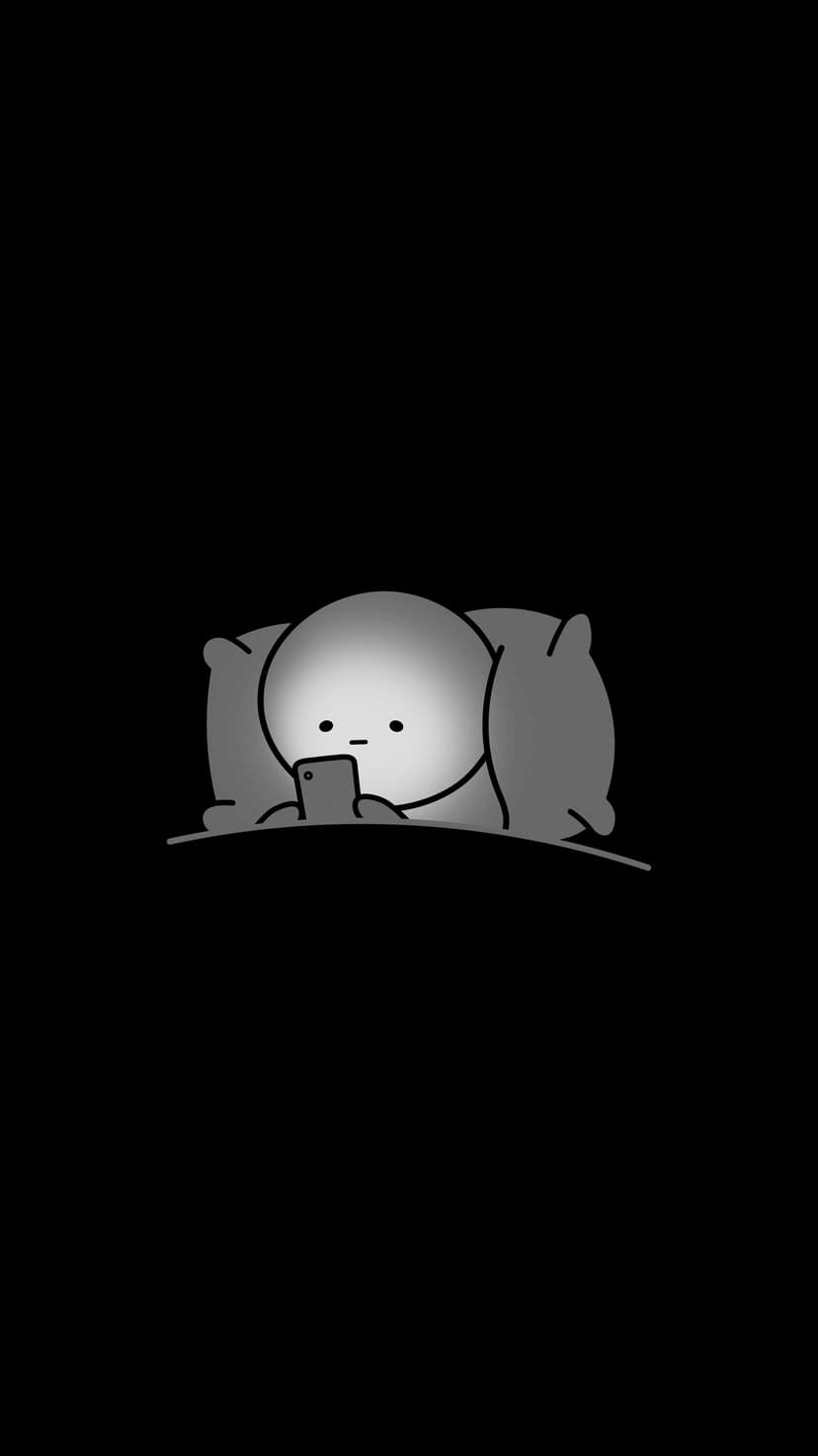 Small round character lies on pillows holding a glowing phone against a solid black background in the dark.