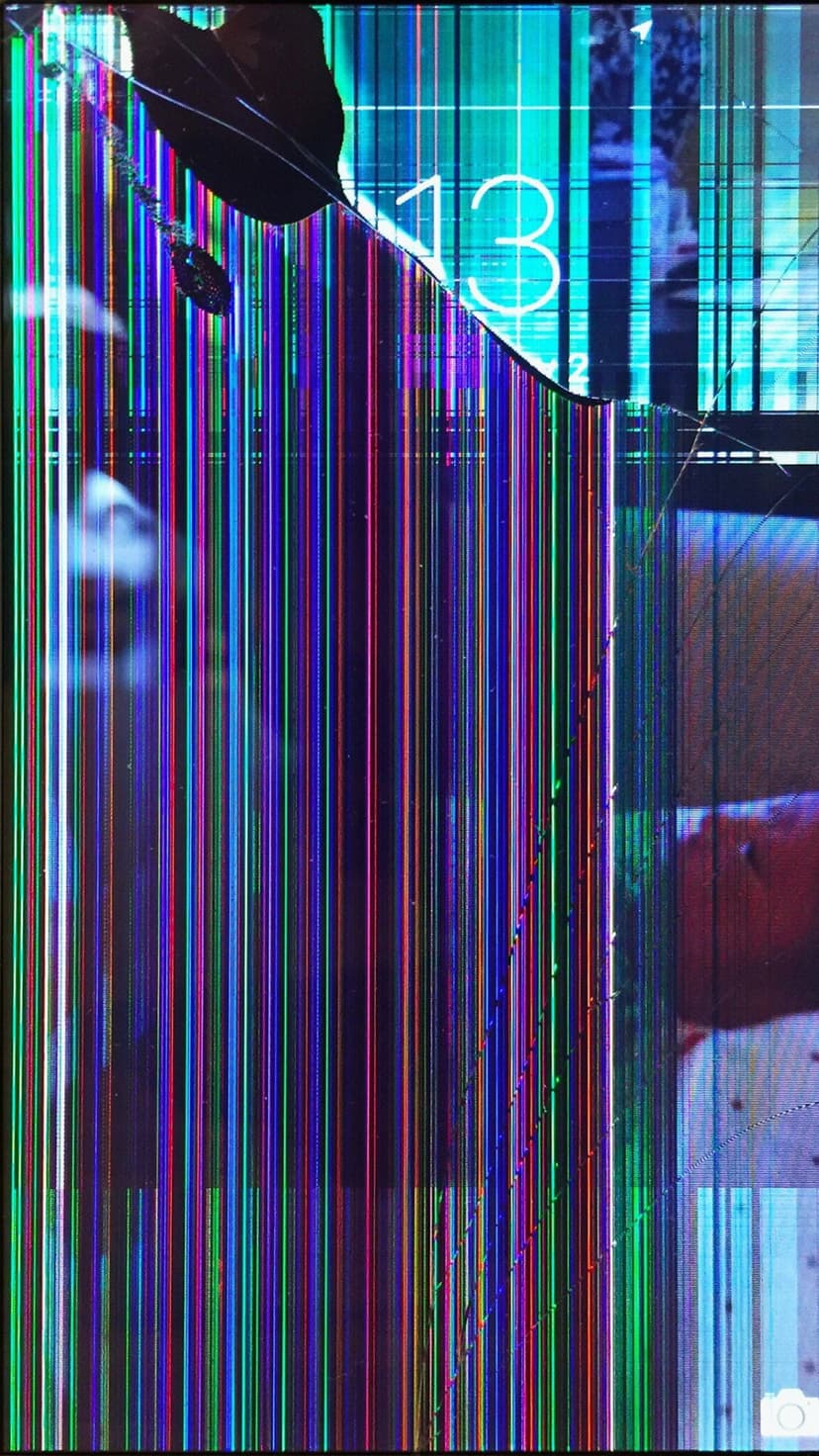 Fractured glass screen showing vertical rainbow stripes and a large numeral 13 through sharp spiderweb cracks.