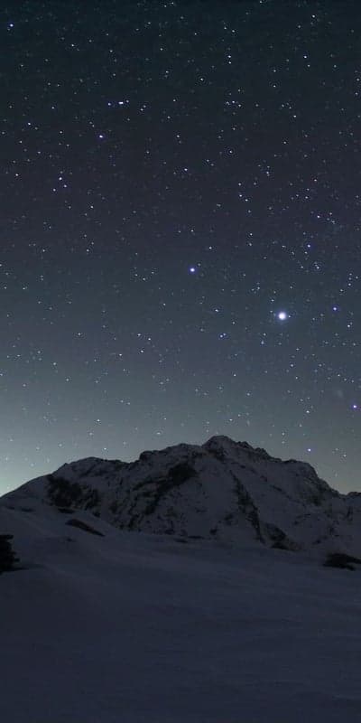 Mountain Sentinel - Snowy Peak Under a Starlit Sky