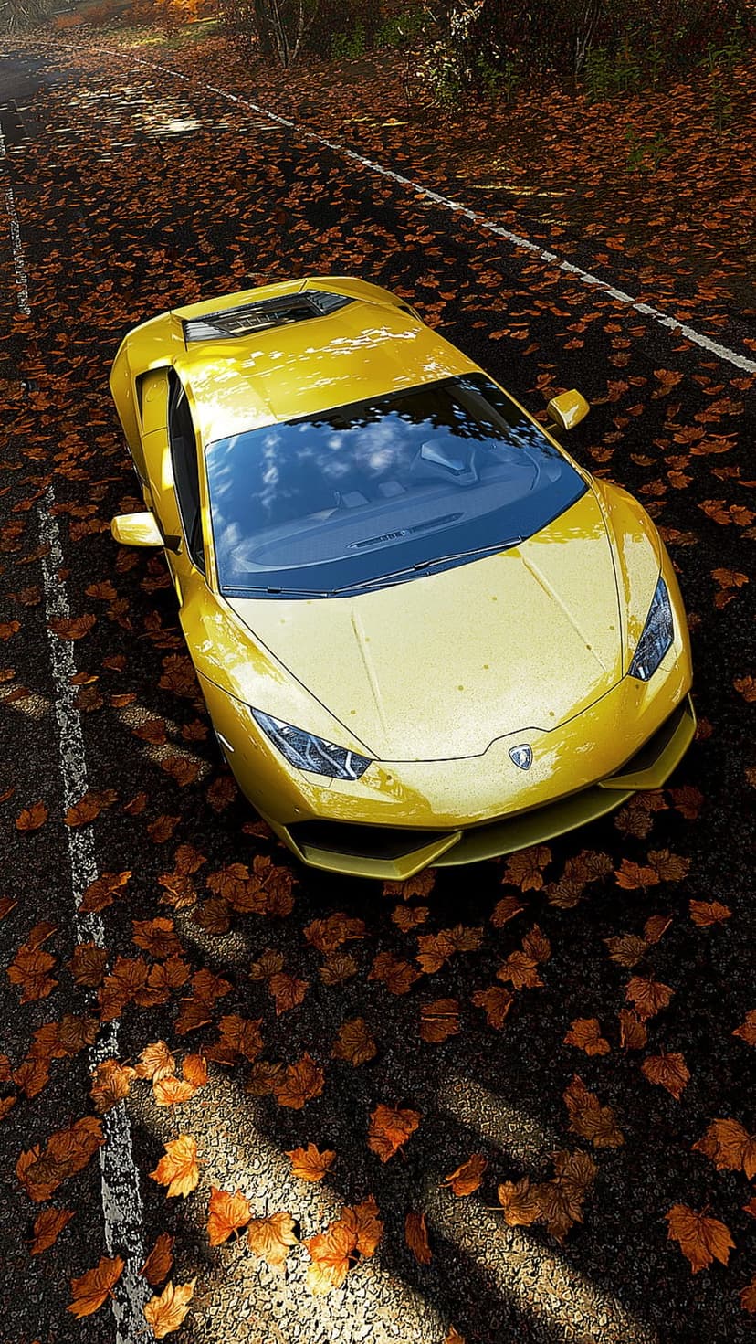 Yellow Lamborghini parked on a road covered in orange autumn leaves under dappled golden sunlight.