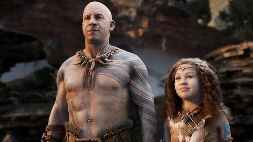Vin Diesel as Santiago with tribal tattoos stands with a young girl in a prehistoric landscape under soft light.