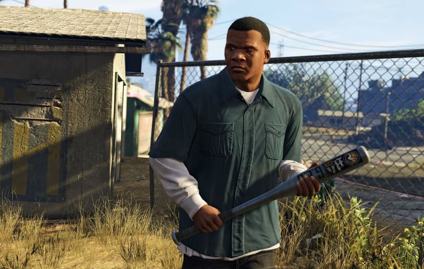 Franklin Clinton holding a metal baseball bat in a sunny urban yard with a chain-link fence and palm trees.