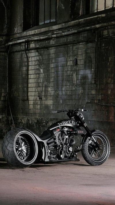 Custom Black Motorcycle in Industrial Setting