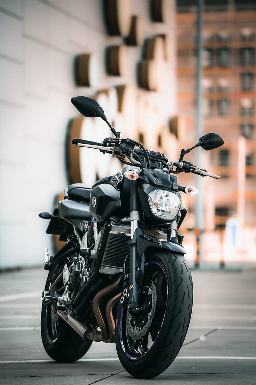 Yamaha MT-07 motorcycle in black featuring a prominent front headlight, handlebars, and a thick rubber tire.