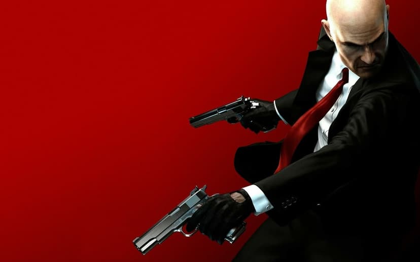 Bald man in a black suit and red tie dual-wielding silver handguns against a solid bright red background.