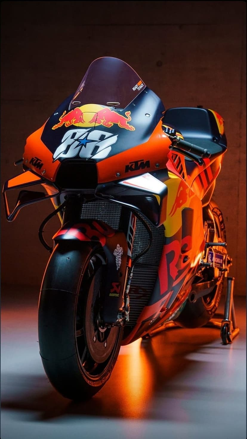 KTM RC16 MotoGP motorcycle with number 88 features glowing orange highlights on aerodynamic racing fairings.