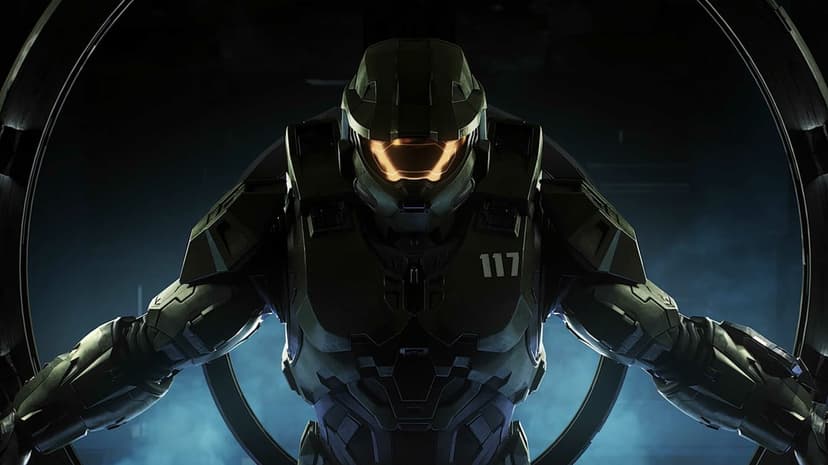 Master Chief in MJOLNIR armor with a glowing orange visor stands centered in a smoky sci-fi hangar.