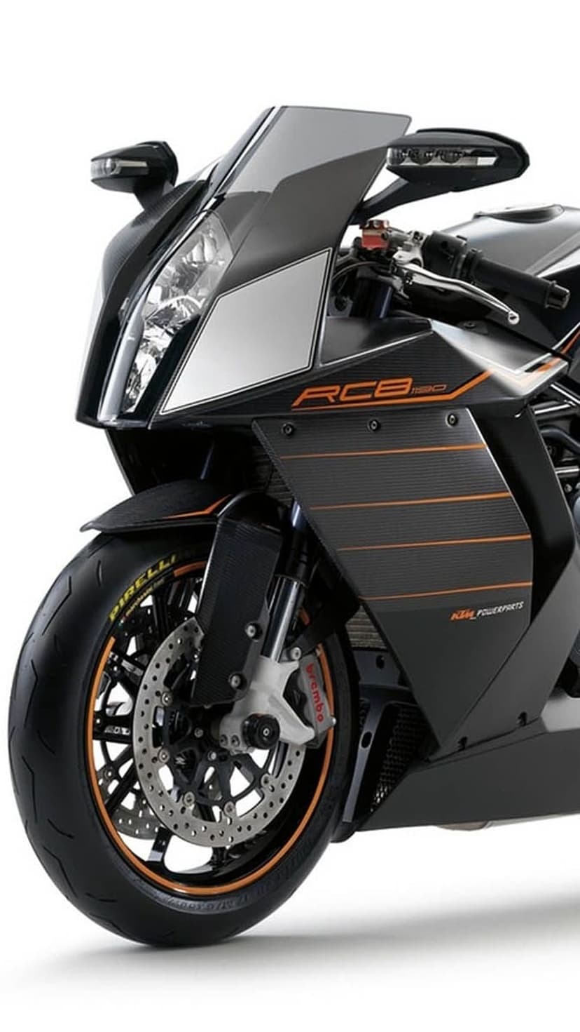 Black KTM RC8 sportbike front view with sharp fairing, orange accents, Brembo brakes, and Pirelli tires on black.