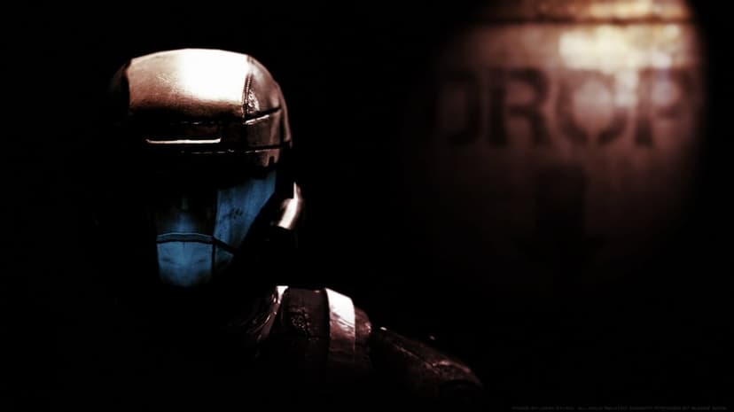 Close-up of a futuristic soldier in dark armor with a glowing blue visor against a shadowy background.