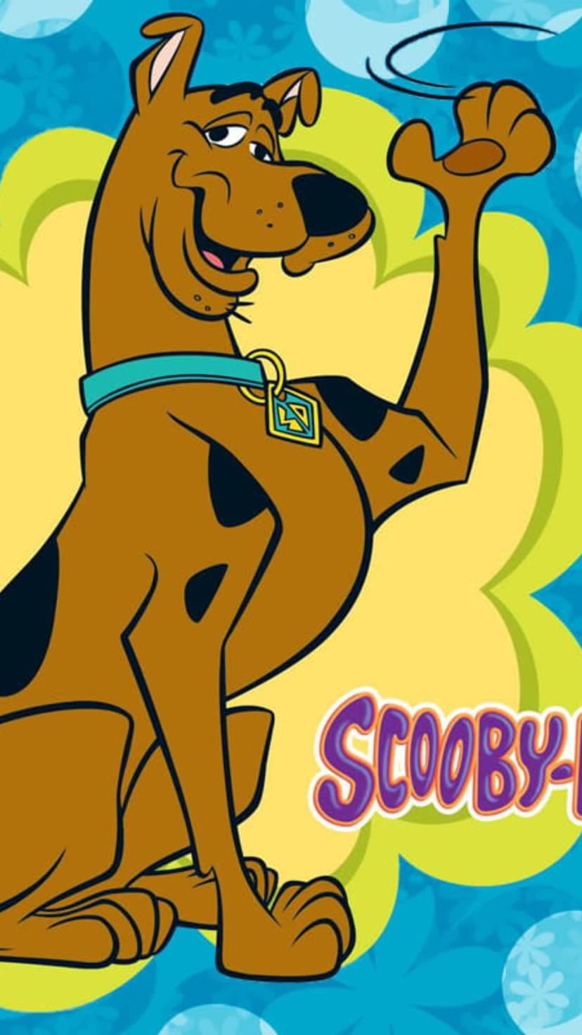 Scooby-Doo smiles with a raised paw wearing a blue collar against a yellow sunburst and blue floral pattern.