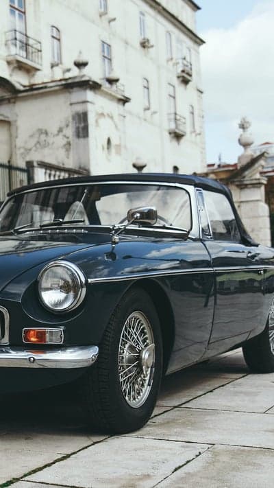 Navy Blue Vintage Roadster and Grand Architecture Wallpaper