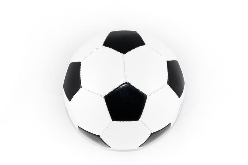 Soccer ball with black pentagons and white hexagons centered on a plain white backdrop in studio lighting.