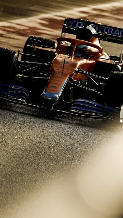 Orange McLaren F1 car on track, close-up