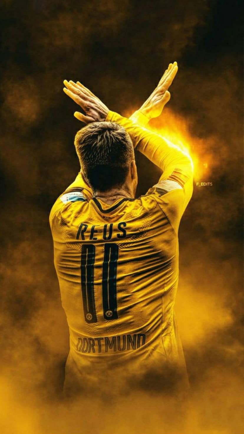 Marco Reus in a yellow BVB jersey crosses his arms amidst glowing orange flames and a radiant golden aura.