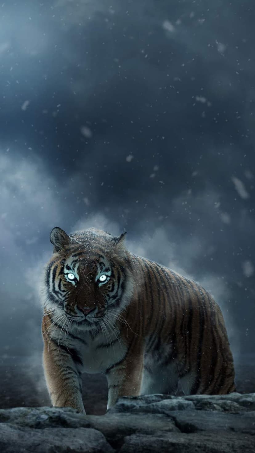 Tiger with glowing blue eyes and snow-covered fur stands under a dark stormy sky during a heavy winter blizzard.