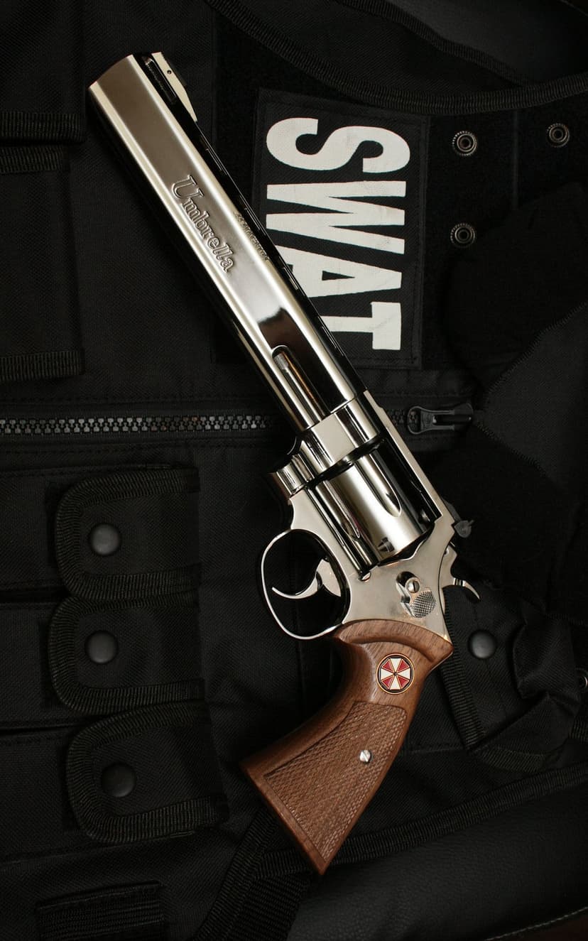 Chrome revolver with a red and white biohazard logo on its grip laying on a black nylon tactical vest.