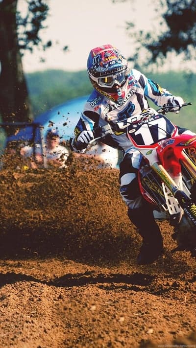 Motocross Rider Speeds Through Dirt Track