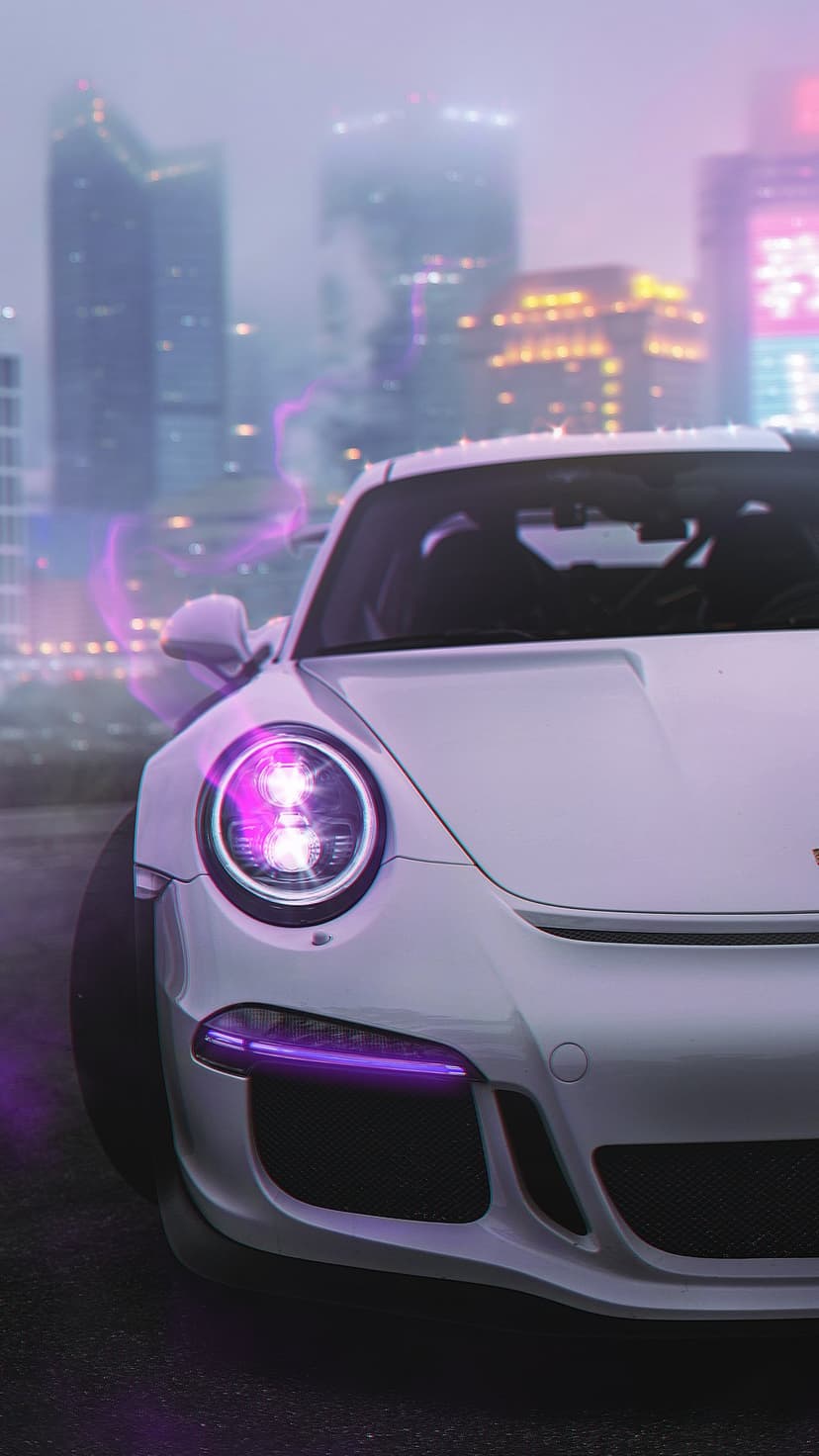 White Porsche 911 GT3 with glowing purple headlights on a night city street near hazy, illuminated skyscrapers.