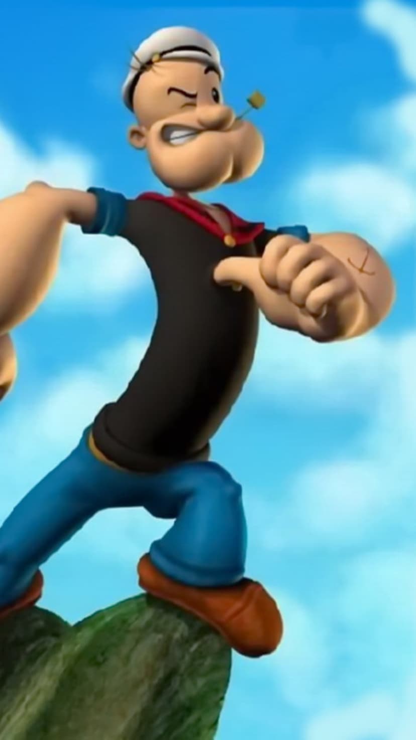 Popeye the Sailor Man winks while holding a pipe in his mouth, standing on a rock against a cloudy blue sky.