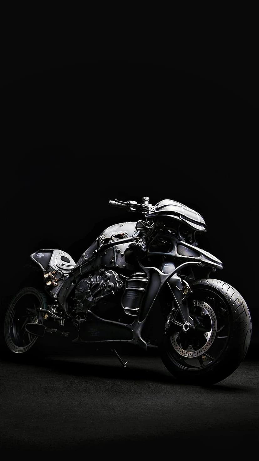Custom futuristic motorcycle with matte black metal parts and intricate gears against a dark background.