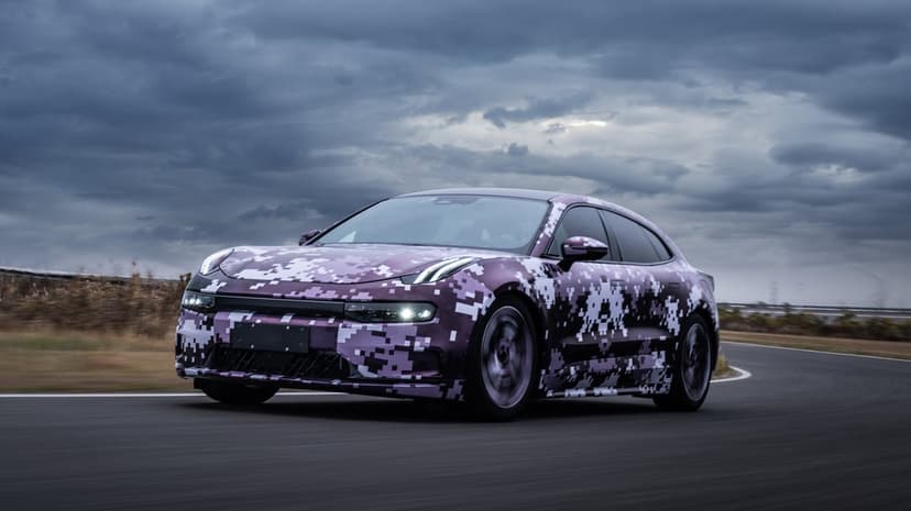 Purple digital camouflage sedan racing on a curved track under dark stormy clouds with motion-blurred wheels.