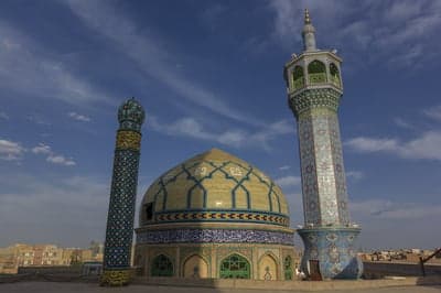 Ornate Mosque Dome and Minaret Under Blue Sky