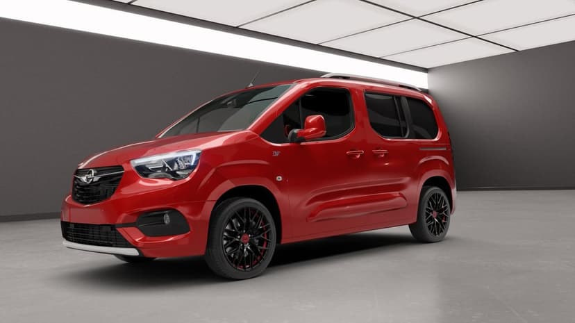 Red Opel Combo Life van with black wheels in a grey studio under bright rectangular white ceiling lights.