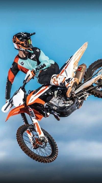 Pro Dirt Bike Rider Mid-Air Stunt Phone Background