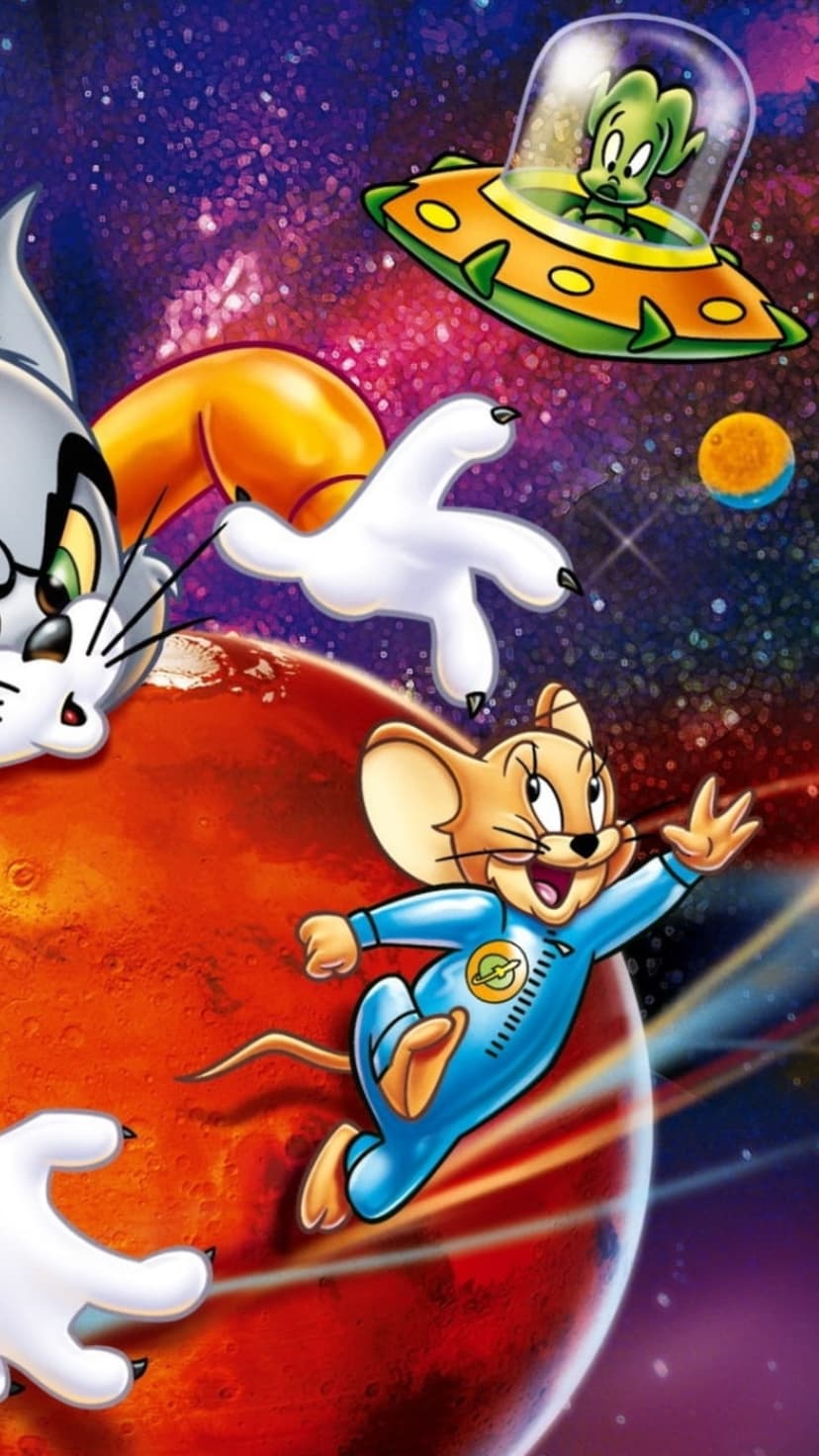 Jerry Mouse in a spacesuit greets a green alien in a UFO while Tom's paw reaches out across a starry galaxy.