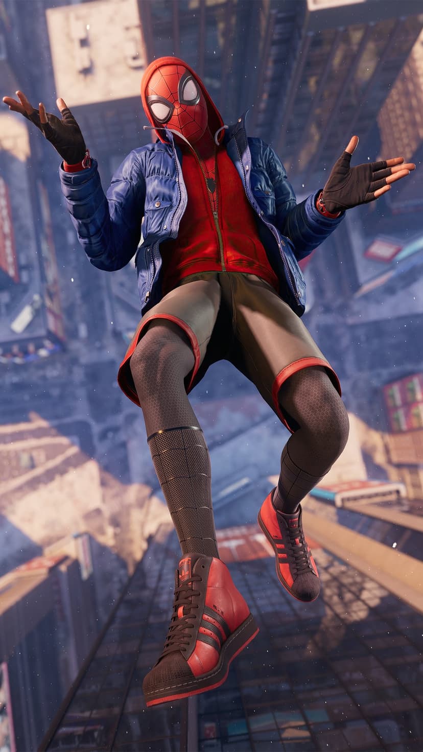Miles Morales sits on a skyscraper edge wearing a blue jacket, red hoodie, and sneakers overlooking a vast city.
