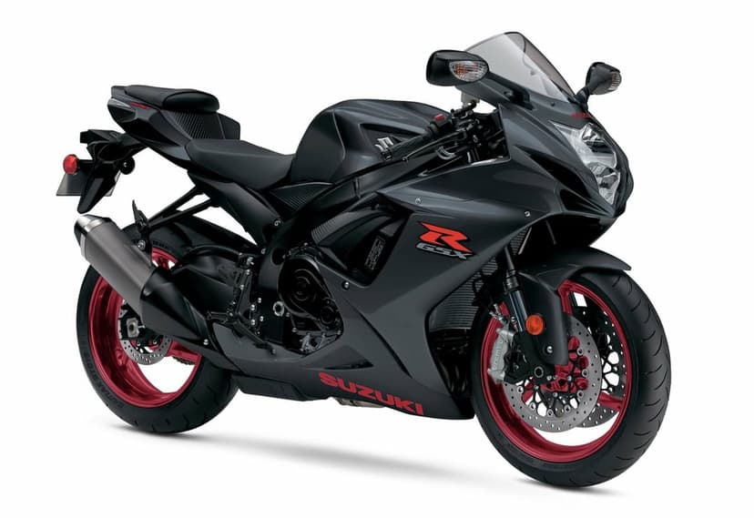 Suzuki GSX-R sport motorcycle in matte black with red wheels and branding against a white background.