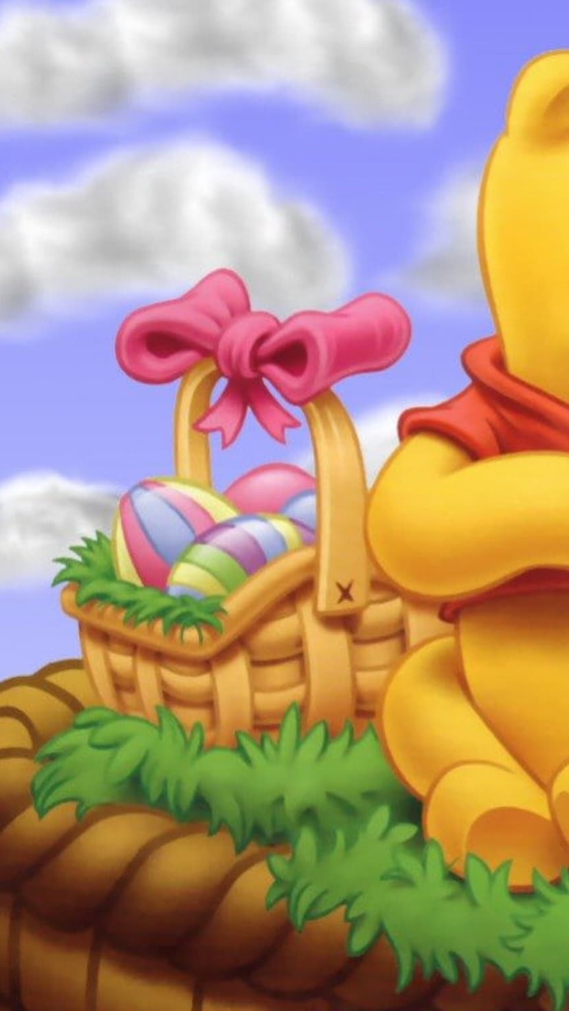 Winnie the Pooh sits by a wicker basket filled with colorful striped eggs under a bright blue sky with fluffy clouds.