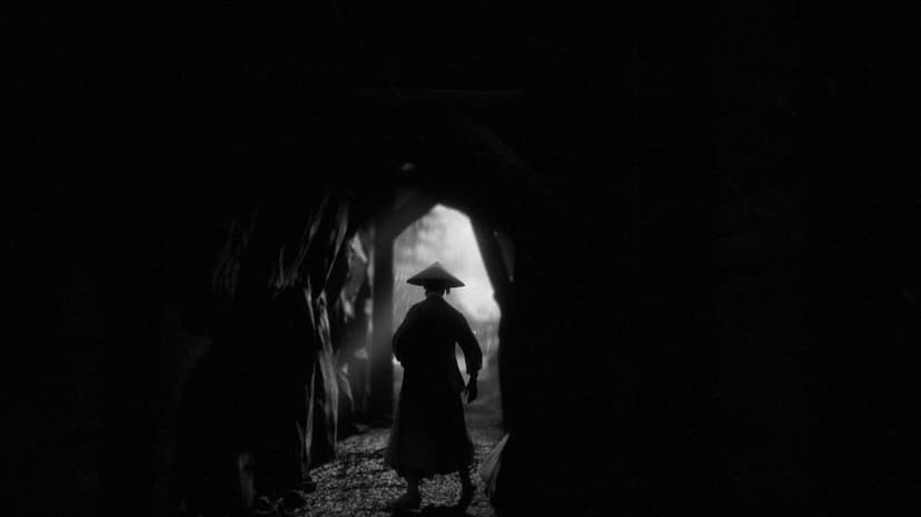 Silhouette of a samurai in a conical hat walking through a dark tunnel toward a bright opening in the rain.