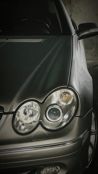 Close-up of Silver Mercedes-Benz CLK Headlight and Hood