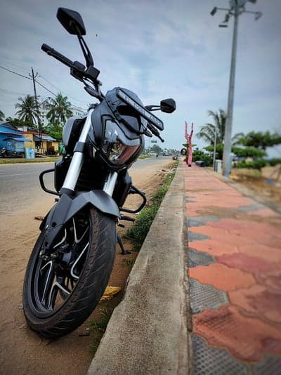 Sleek Black Cruiser Motorcycle Beachfront Mobile Wallpaper