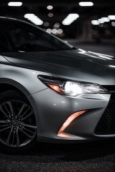 Close-up of a Silver Toyota Camry Headlight and Wheel