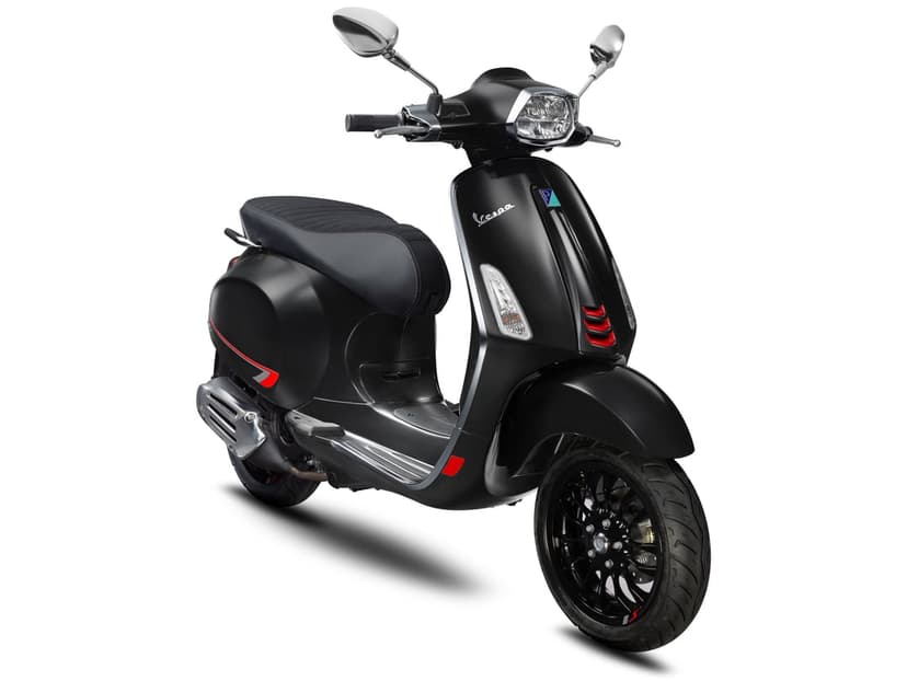 Matte black Vespa Sprint S scooter with red accents and chrome mirrors isolated on a clean white background.