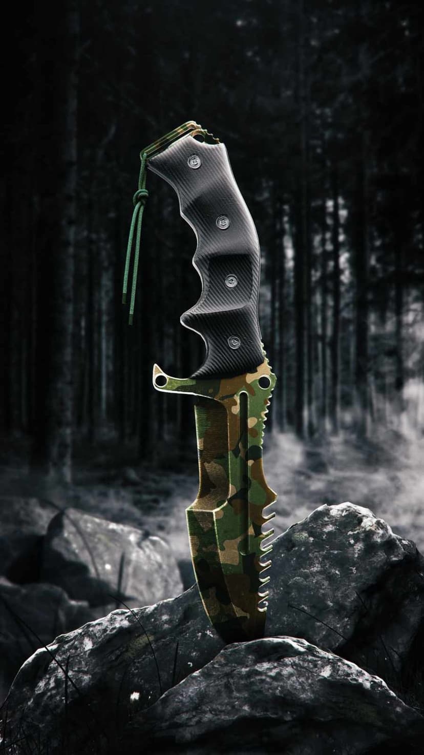 Camouflage survival knife standing upright on gray forest rocks with a dark, misty woodland in the background.