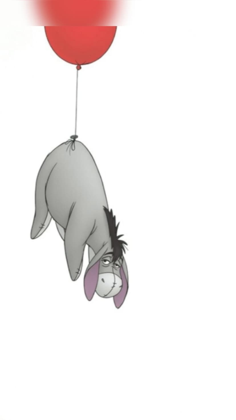 Eeyore hangs upside down by a string from a bright red balloon, displaying a sad expression against a plain backdrop.
