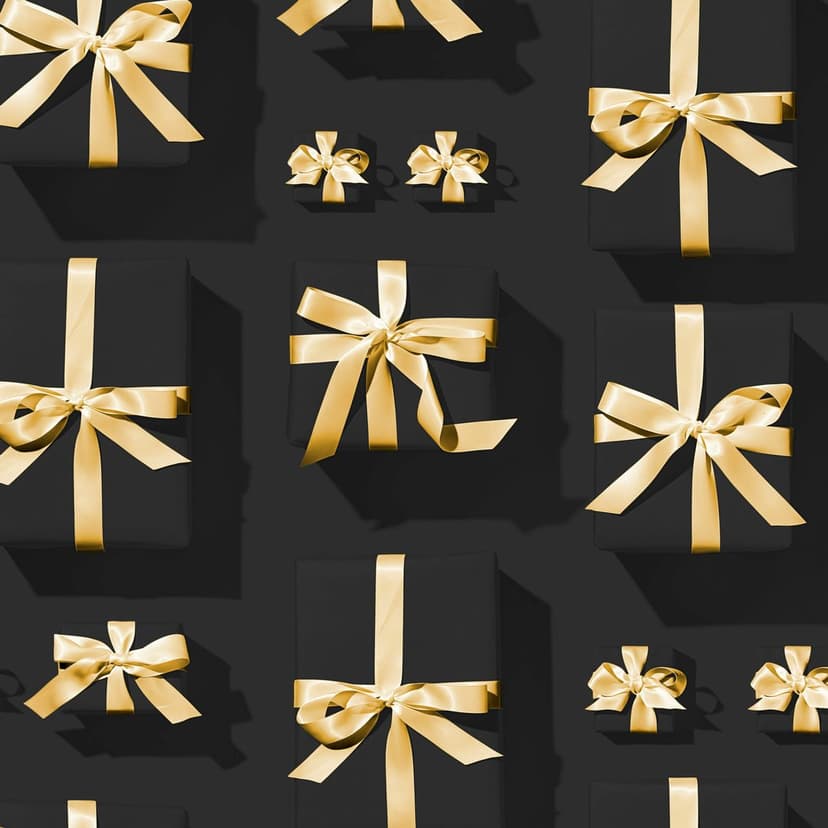 Matte black gift boxes with metallic gold bows create a repeating pattern across a dark textured surface.