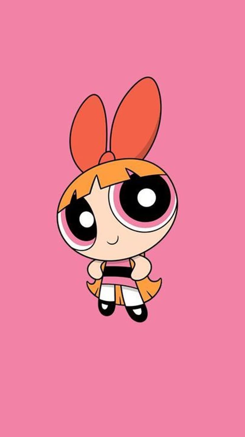 Blossom with large pink eyes and a giant orange bow smiles against a solid pink background in a vertical layout.
