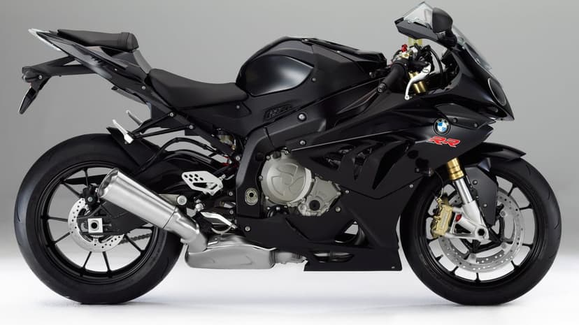 Black BMW S1000RR sportbike side profile with metallic exhaust and gold forks on a gray studio background.