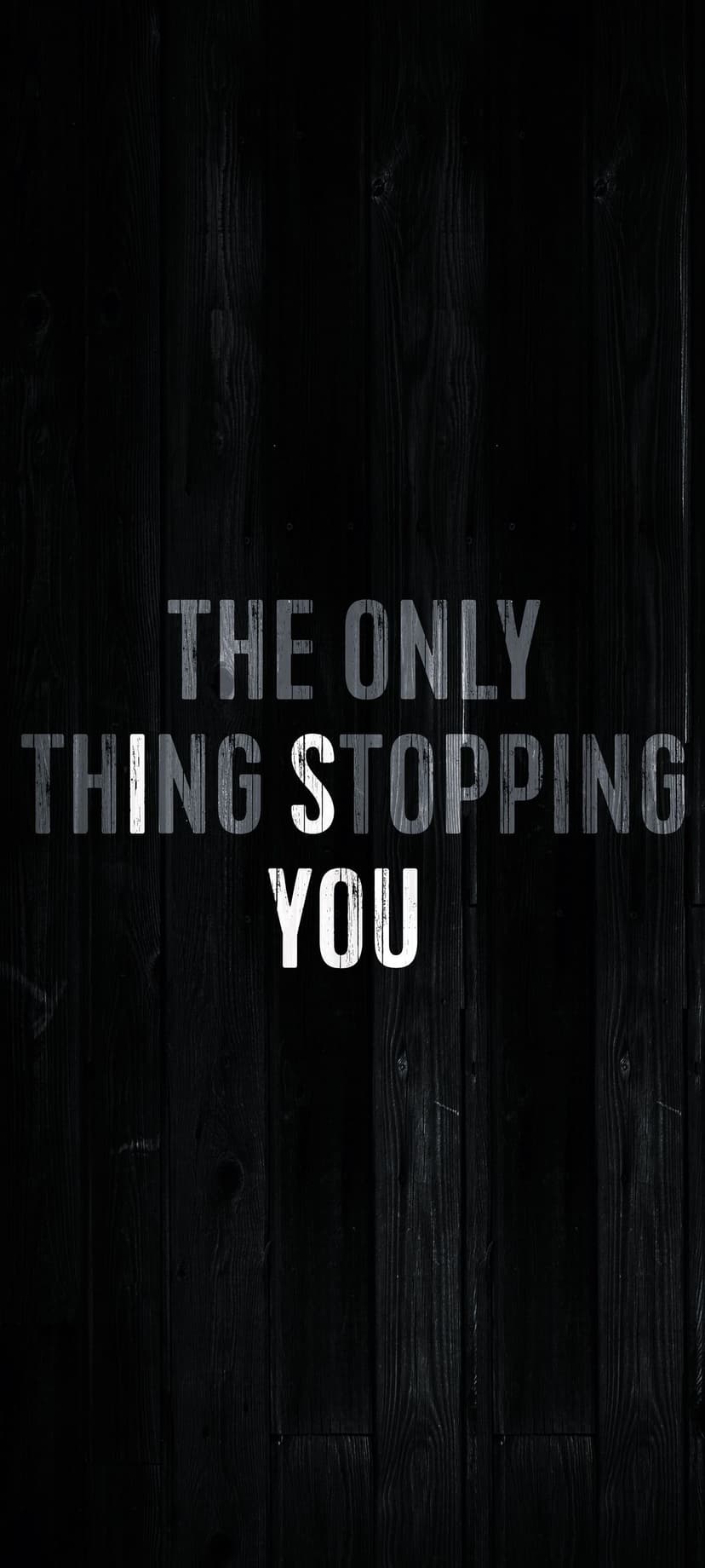Distressed white block lettering on dark brown wooden planks displays an inspirational self-empowerment message.