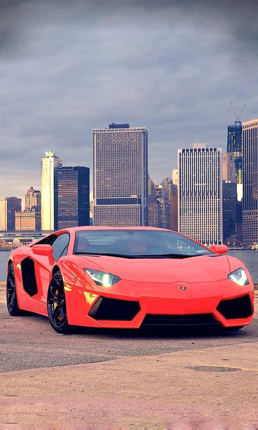 Red Lamborghini Aventador on a New York waterfront with the Freedom Tower and skyscrapers in the background.