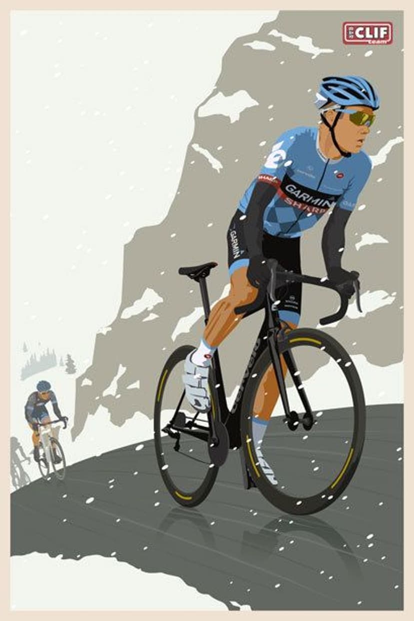Professional cyclist in blue apparel climbs a snowy mountain pass with falling flakes on a winding road.