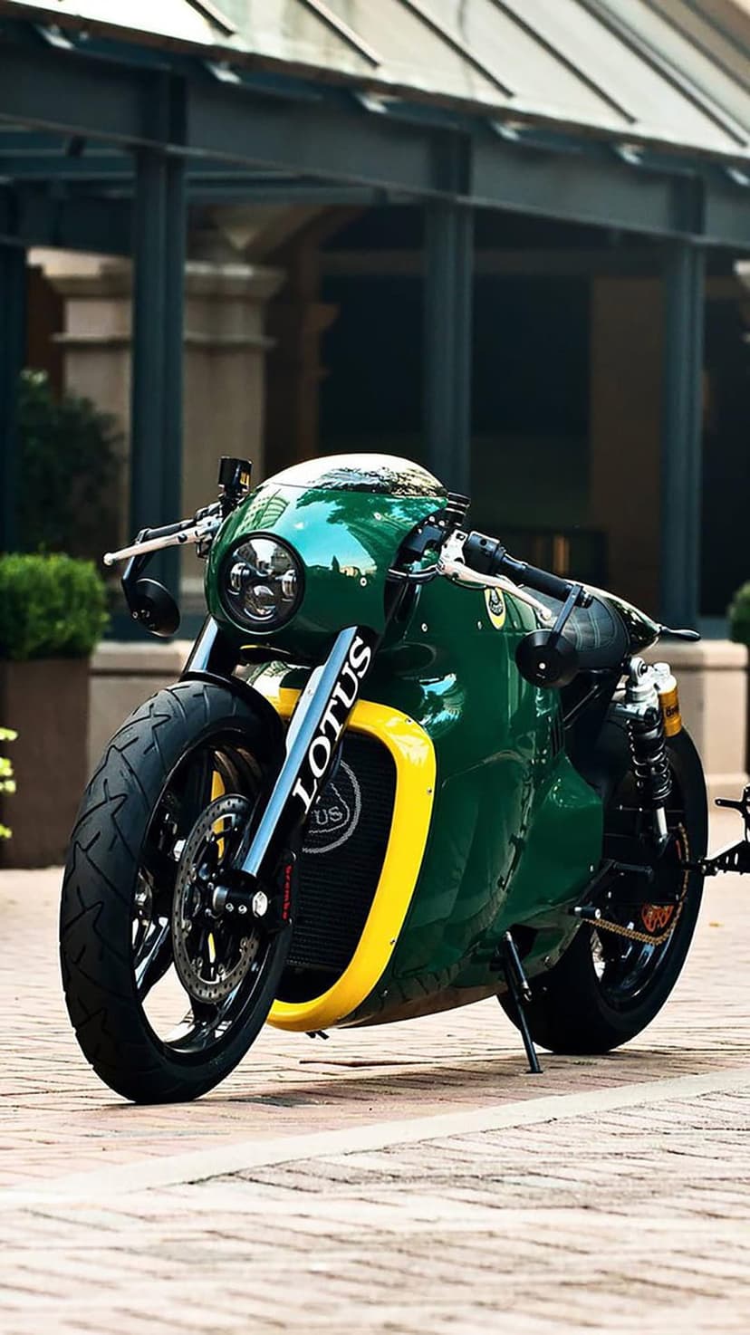 Lotus C-01 cafe racer motorcycle with green fairings and yellow accents parked on a paved stone walkway.