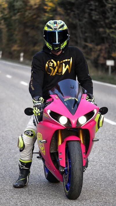 Pink Motorcycle Rider in Full Gear on Road