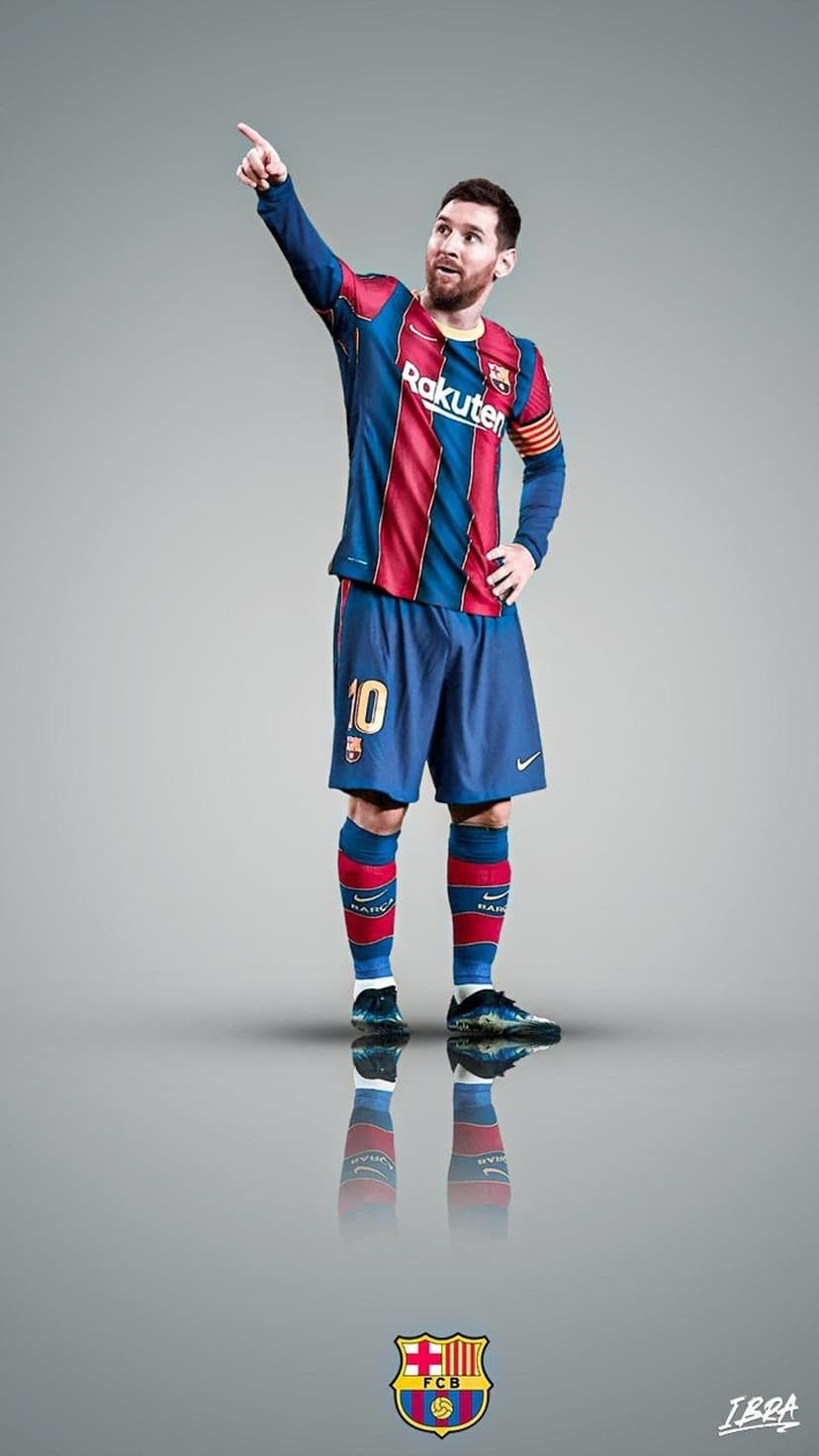 Bearded soccer player in a red and blue jersey pointing upward on a reflective grey floor with a club logo.