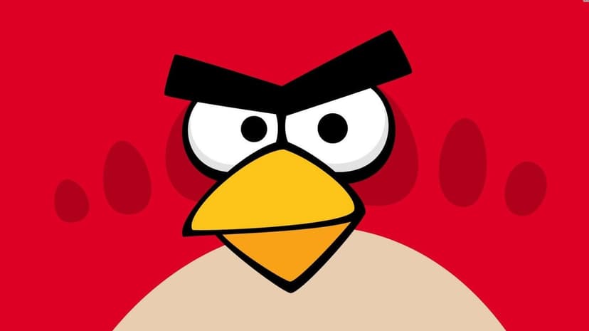Close-up of Red from Angry Birds with thick black eyebrows and a sharp yellow beak on a vivid red background.