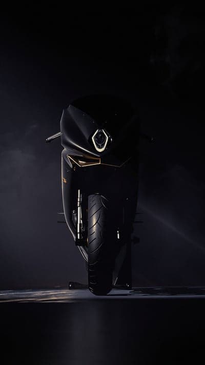 Black Sportbike Motorcycle with Gold Accents in Dark Setting
